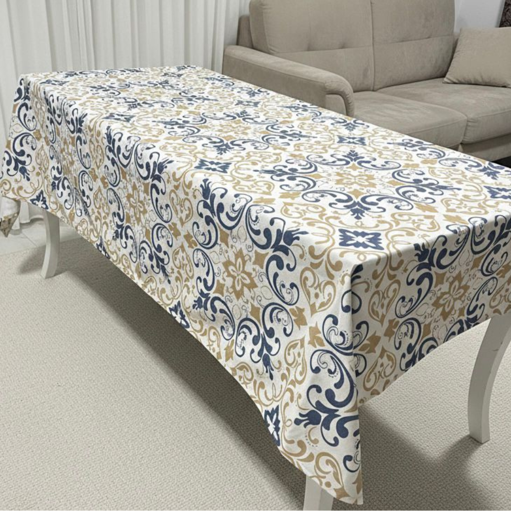 Patterned tablecloth on a dining table with a beige sofa in the background