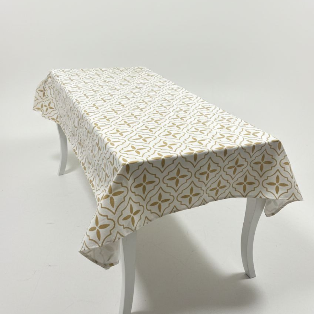 Table with a patterned tablecloth on a plain background
