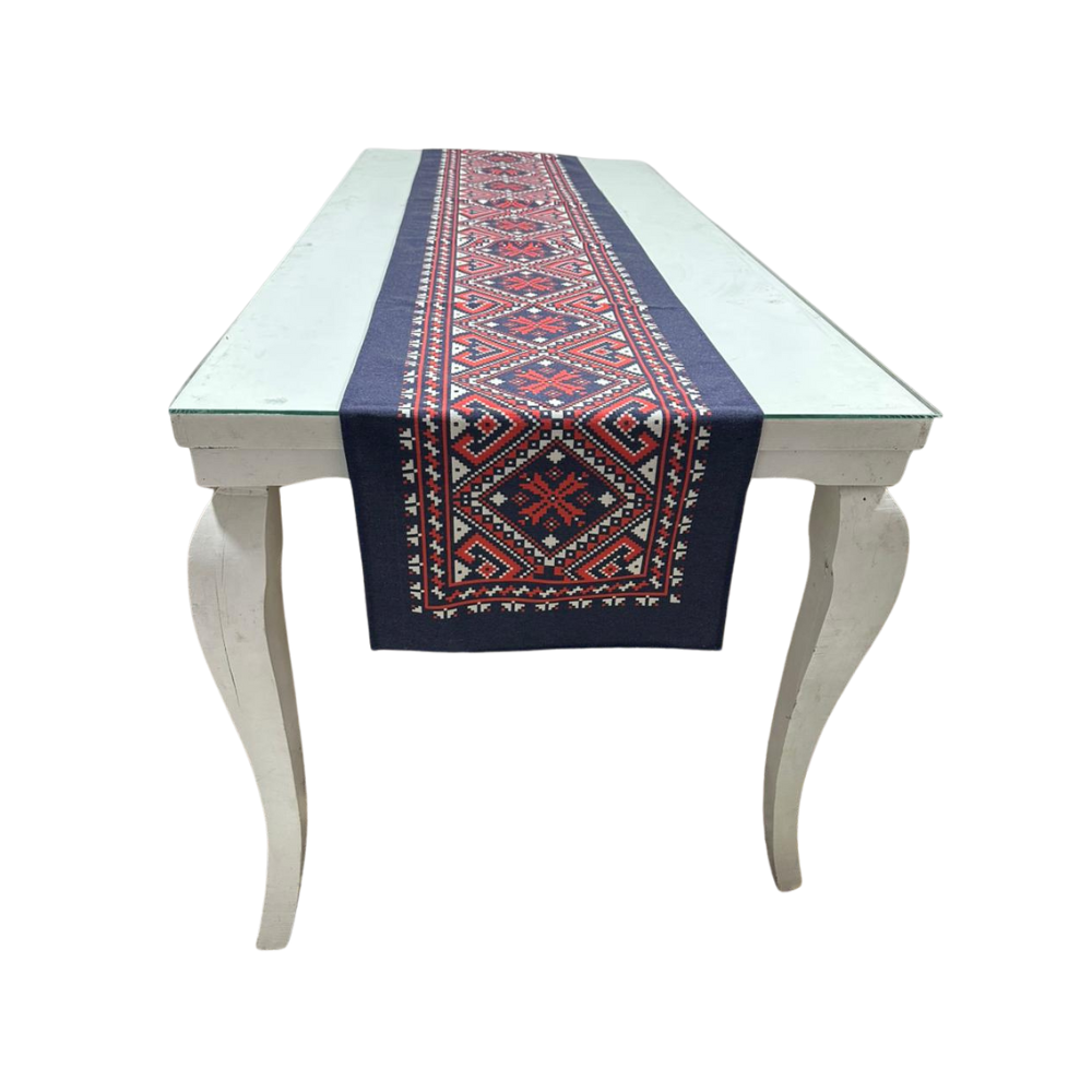 Table with a decorative table runner on a white background