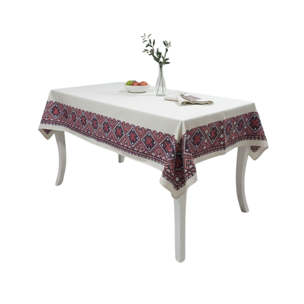 Table with a decorative tablecloth featuring a red and blue pattern on a white background